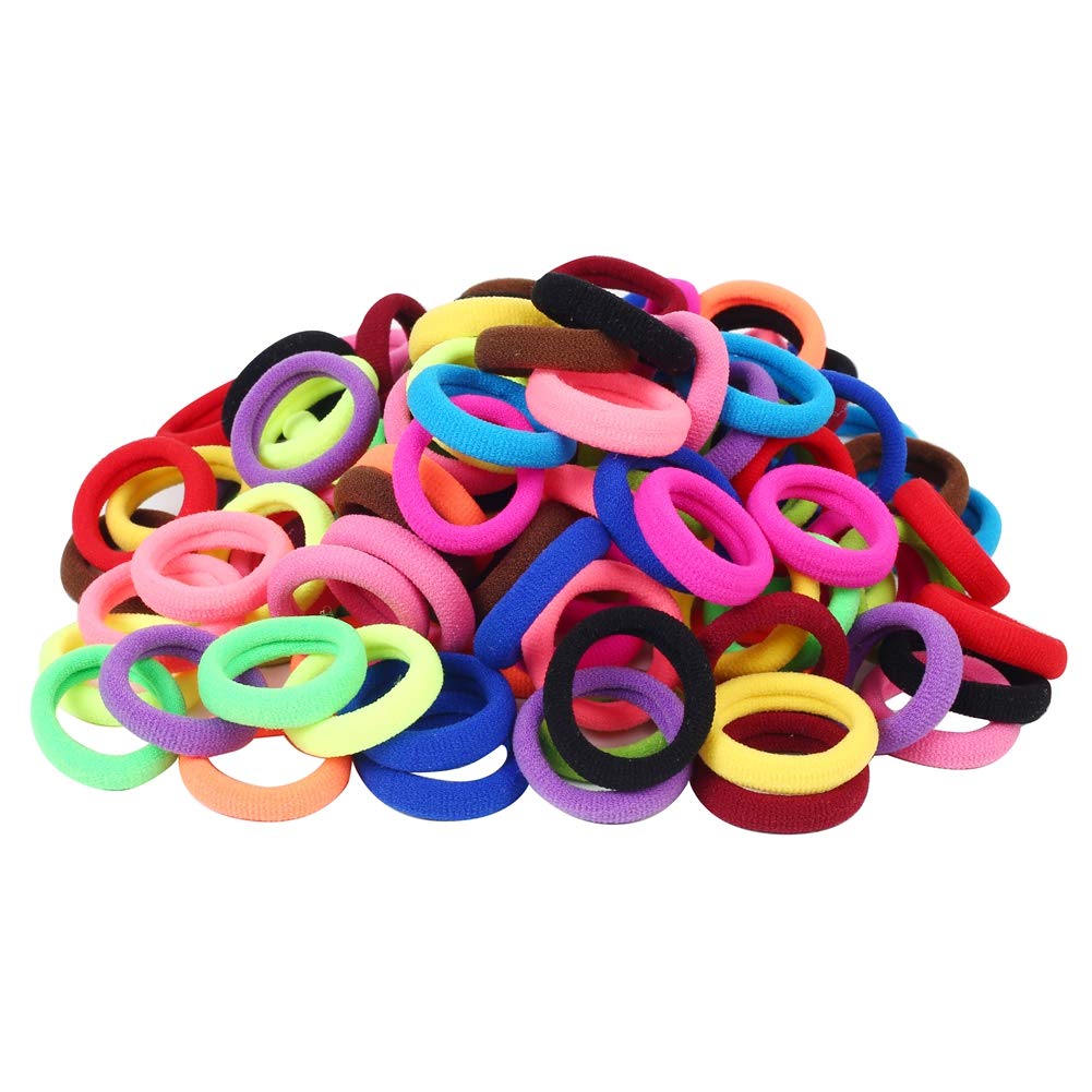 Seamless cotton toddler hair bands in fifteen different colors spread out on table