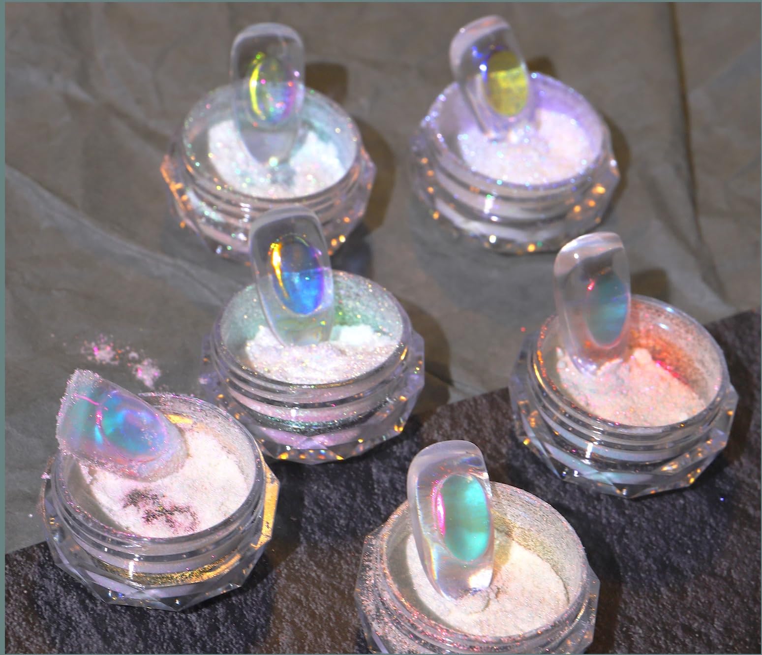 Model wearing nails with mirror-like chrome aurora effect