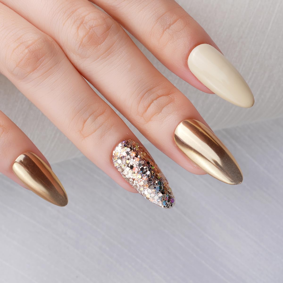 Professional nail technician applying chrome powder to nails