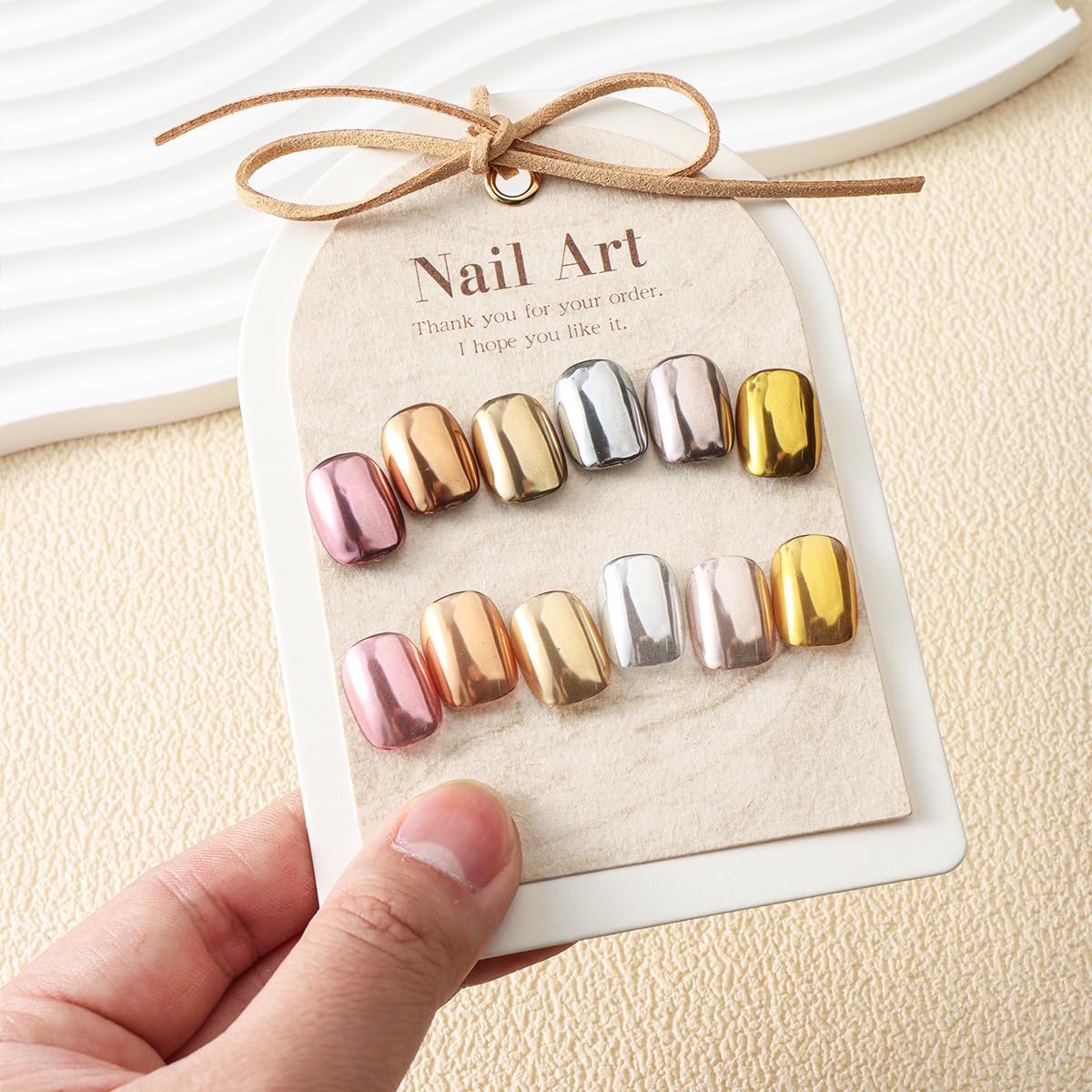 Applying metallic mirror pigment to nails with applicator