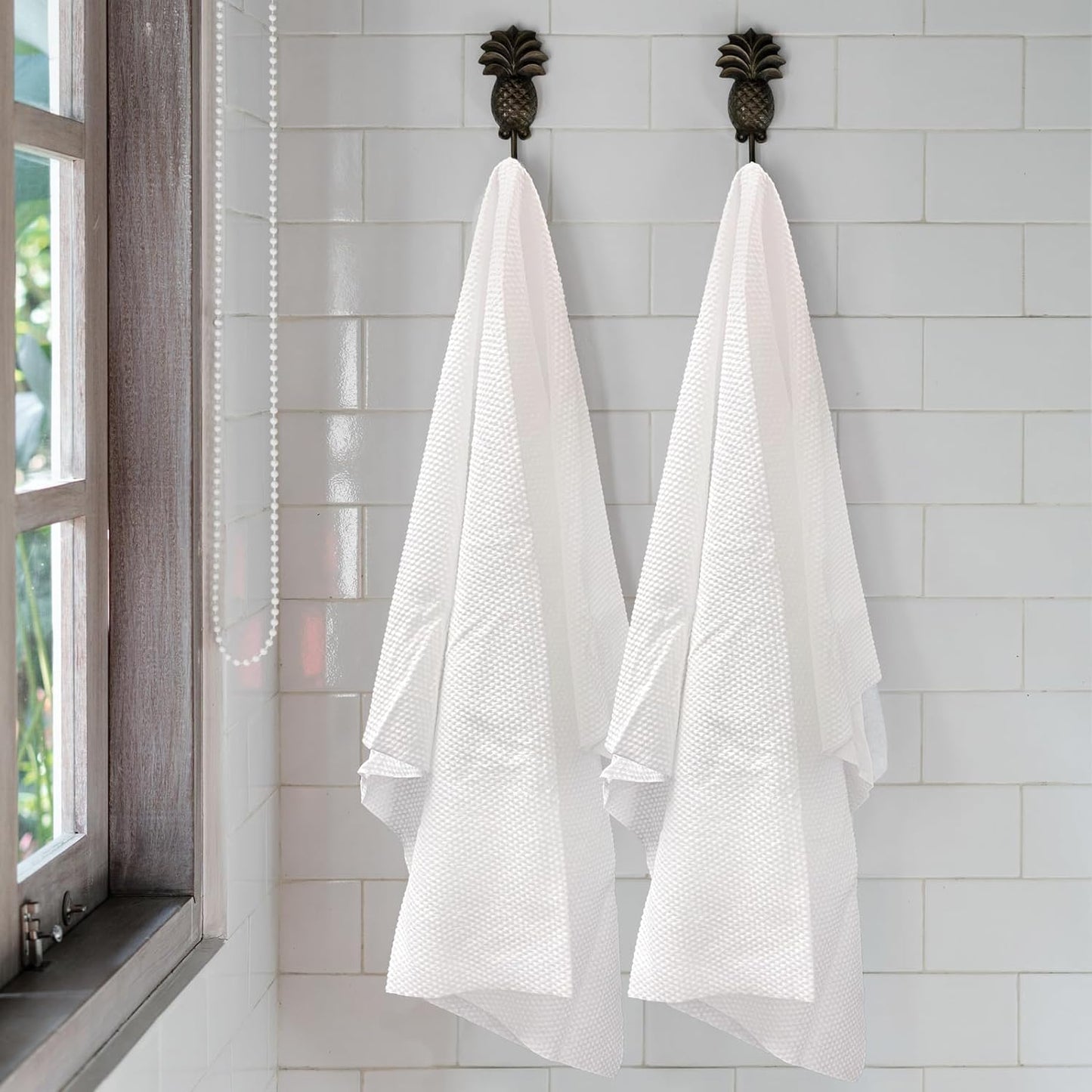 White disposable salon sheets stacked neatly for professional use