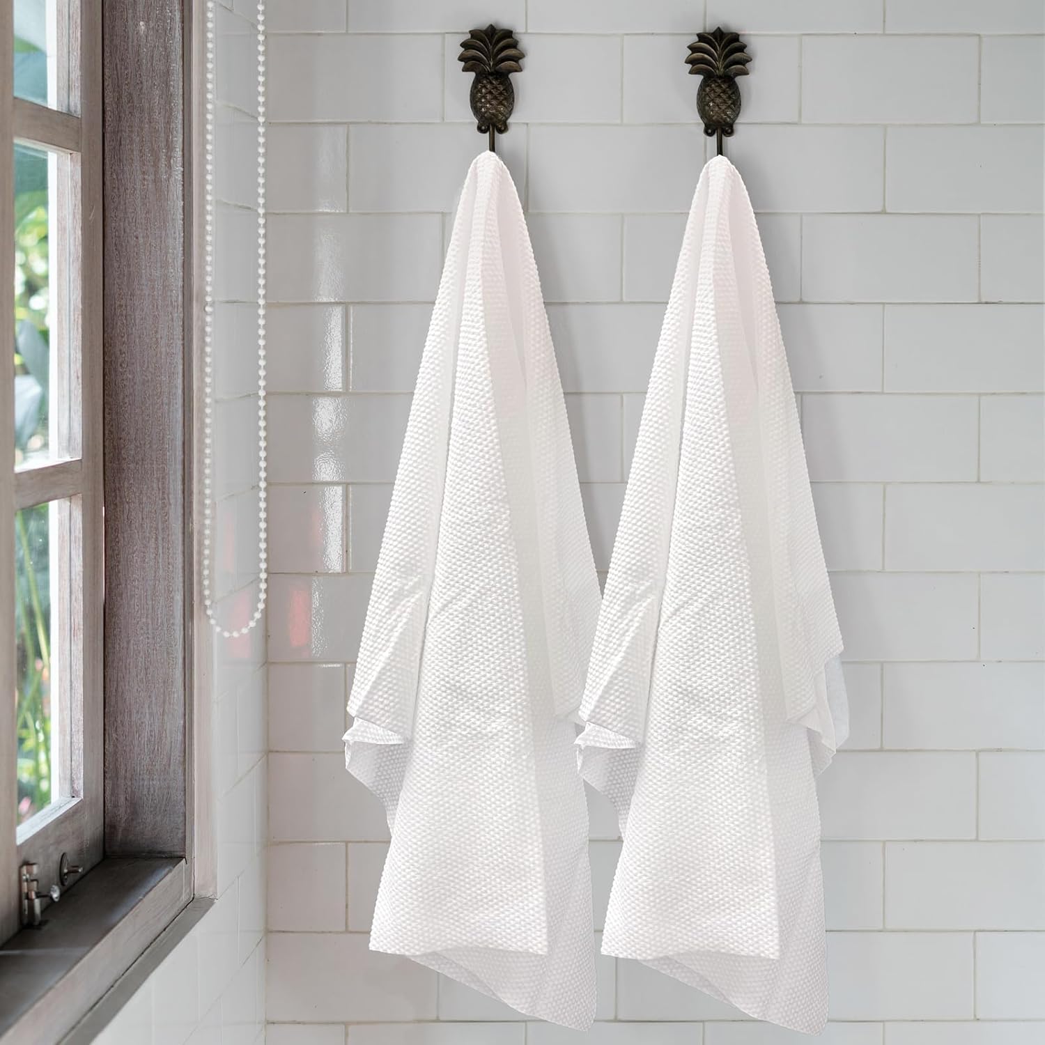 White disposable salon sheets stacked neatly for professional use