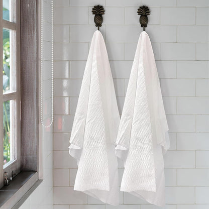White disposable salon sheets stacked neatly for professional use