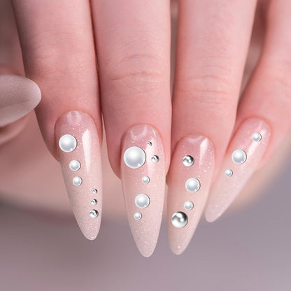 Application of white pearl beads on professional nail art design
