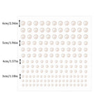 Close-up view of flat-back white faux pearl stickers on backing paper.