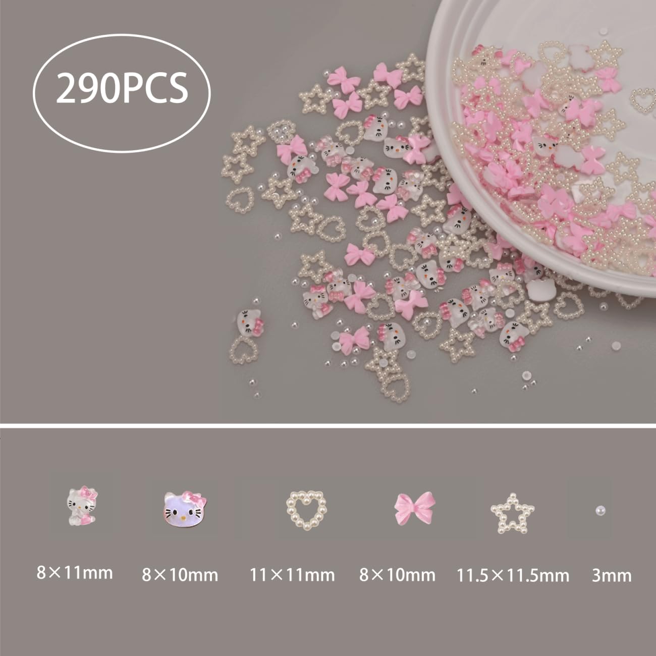 Close up view of pink and white 3D coquette nail art charms