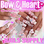 Assorted pink and white bow nail charms in grid box