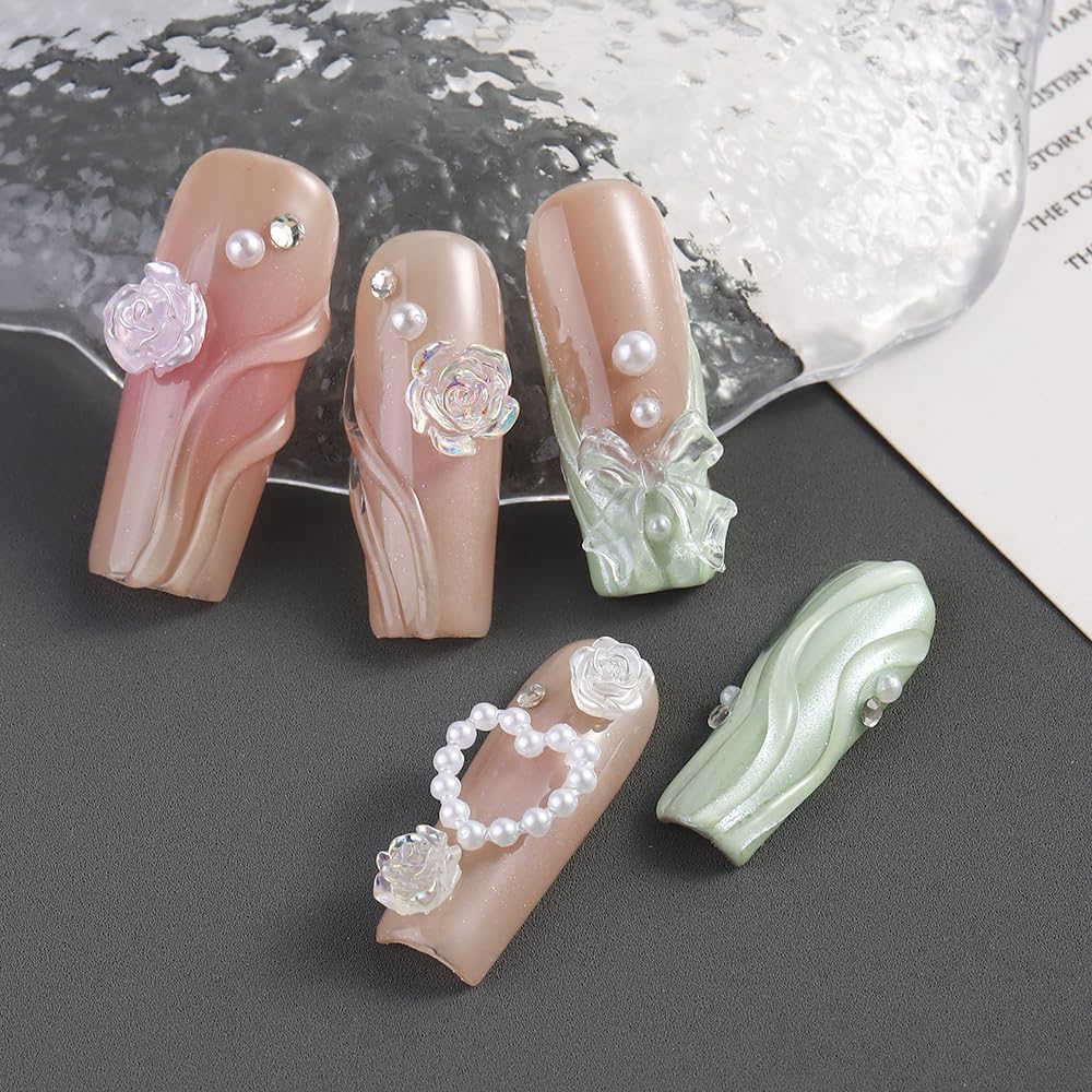 Applying resin bow nail charms with tweezers