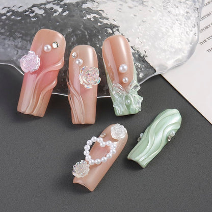 Applying resin bow nail charms with tweezers