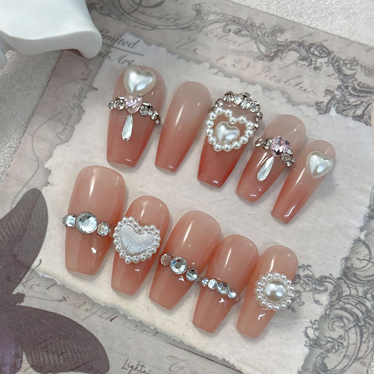 Close up of mixed style heart shaped flatback pearls for nail art