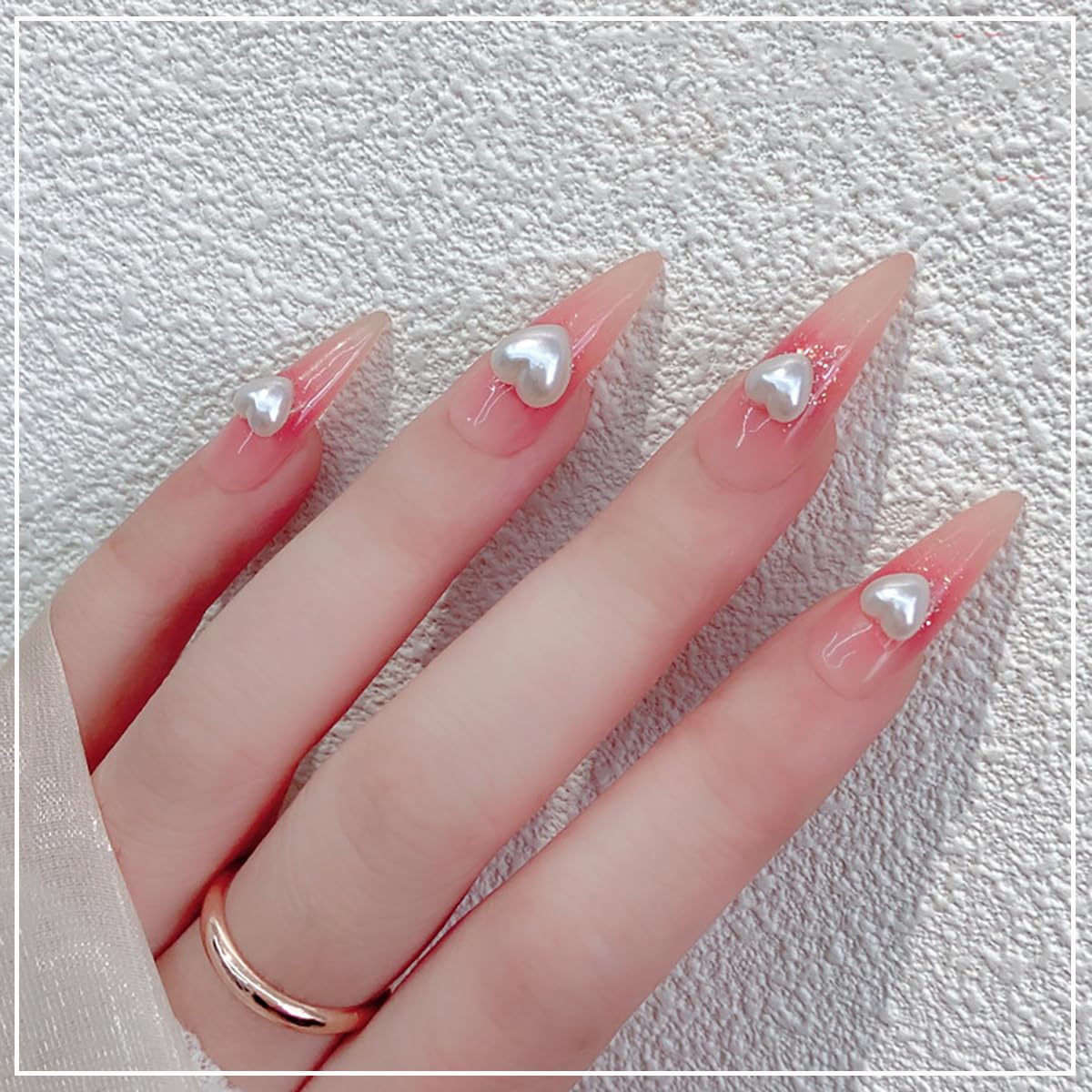 Creamy white 3D pearl nail charms used on professional acrylic nails