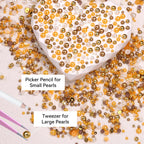 Close-up of metallic gold and yellow round nail art beads