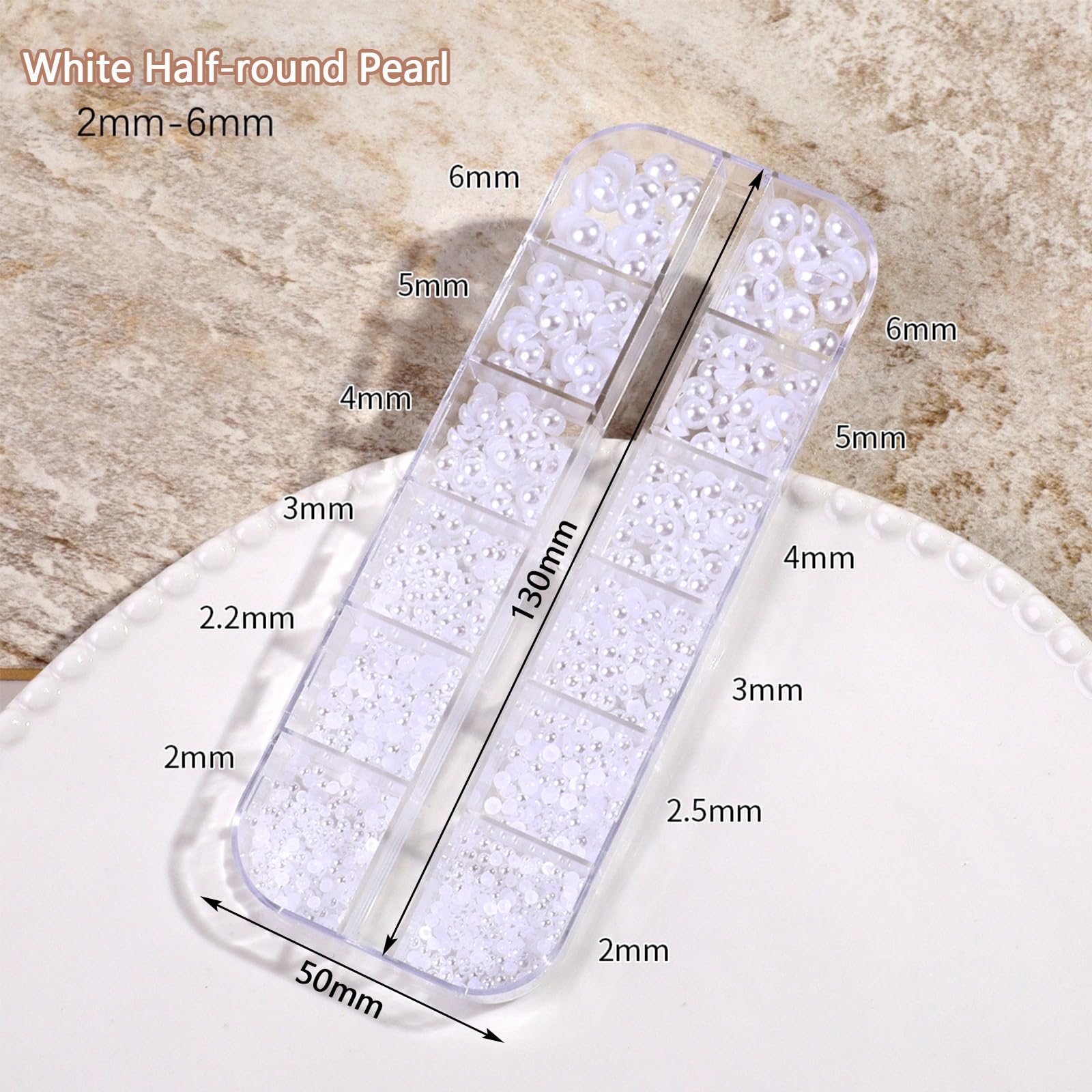 Open boxes of white flatback pearls and resin charms