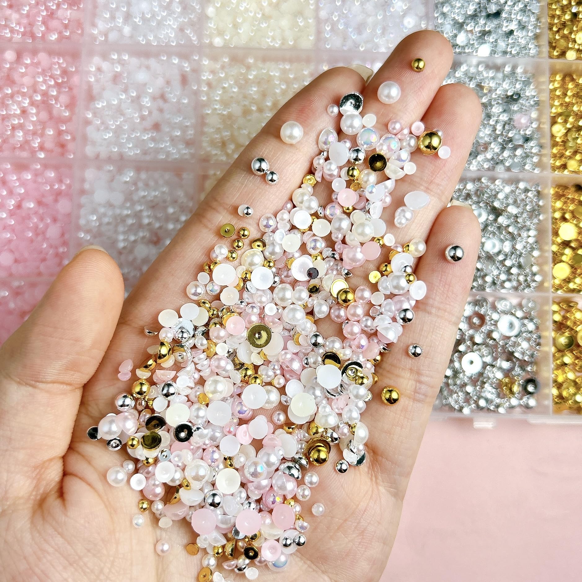 Close up of mix sizes flatback pearl nail art charms in grid container