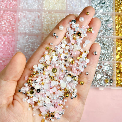 Close up of mix sizes flatback pearl nail art charms in grid container