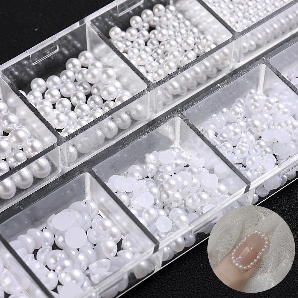 Detailed view of white pearl charms used on acrylic nail extensions