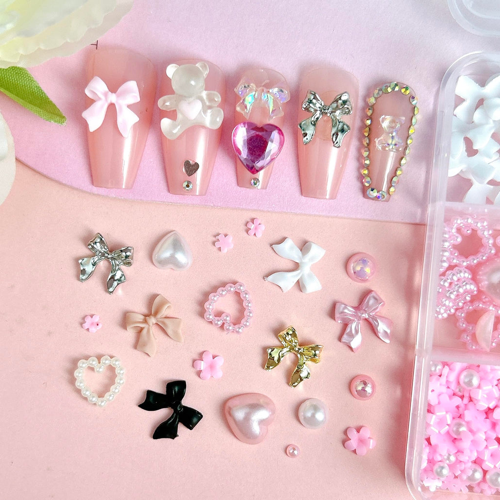 Manicure display showing acrylic nails decorated with resin bows
