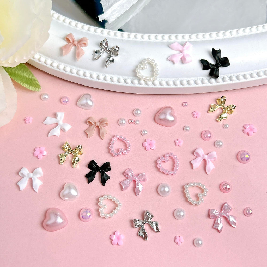 Open 12 compartment storage box showcasing full nail charm assortment