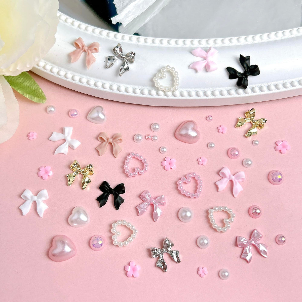 Open 12 compartment storage box showcasing full nail charm assortment