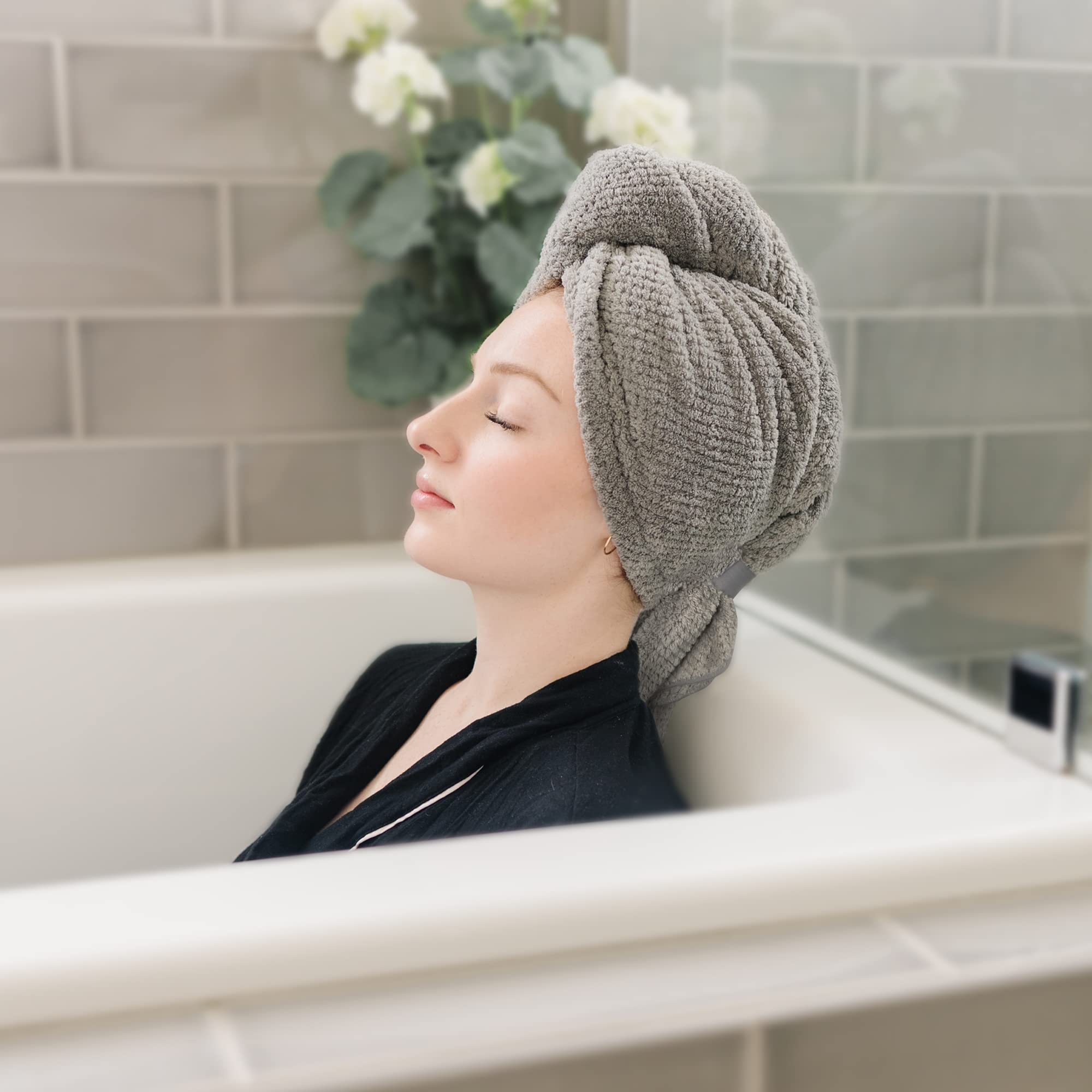 Woman using quick dry hair wrap for curly hair