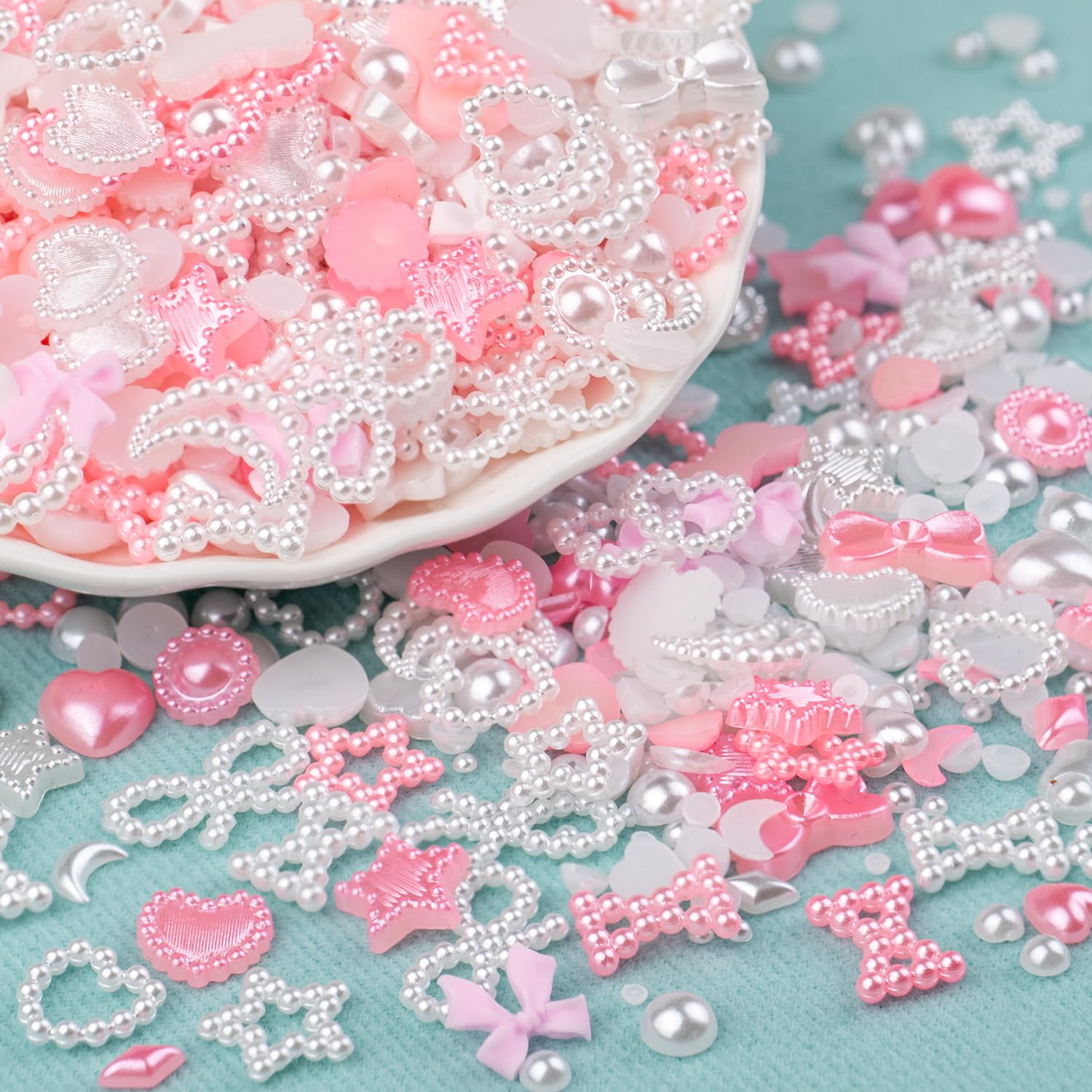 Assorted white and pink nail art charms with tweezer and pencil