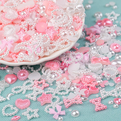 Assorted white and pink nail art charms with tweezer and pencil