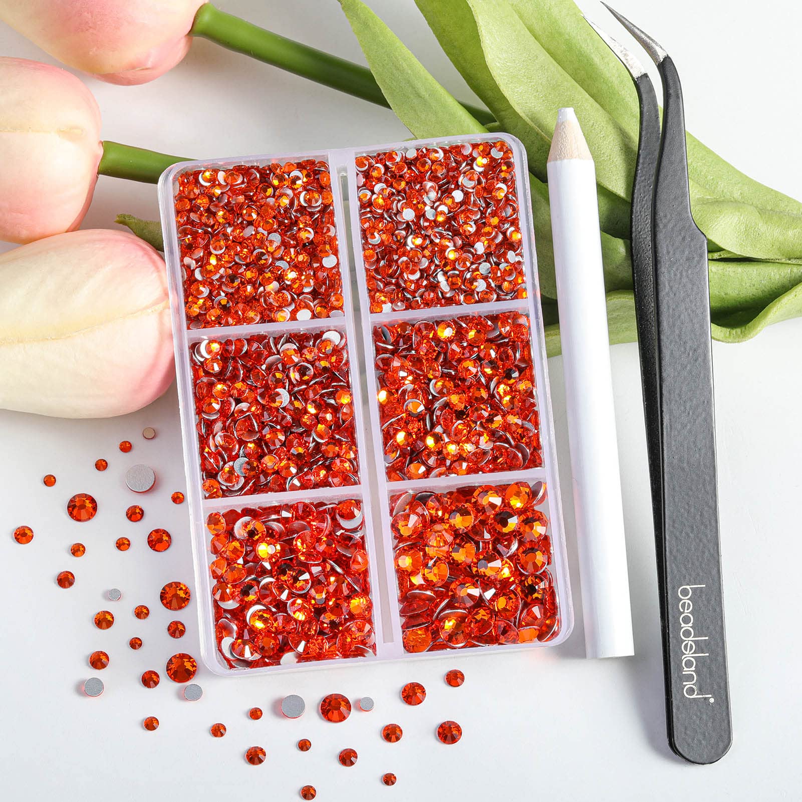 Beadsland orange nail gems sorted in partitioned storage box