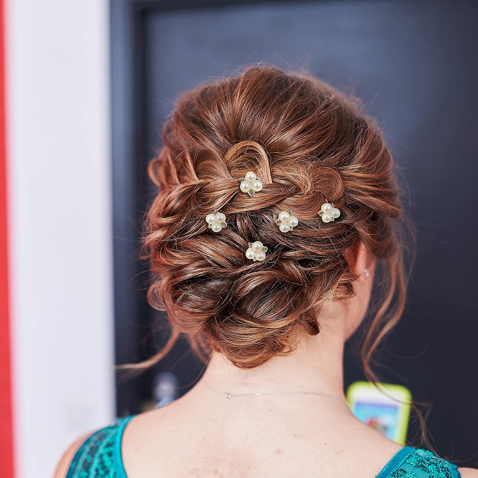 The elegant gold bridal hair pins laid out on a clean backdrop highlighting the faux pearl design