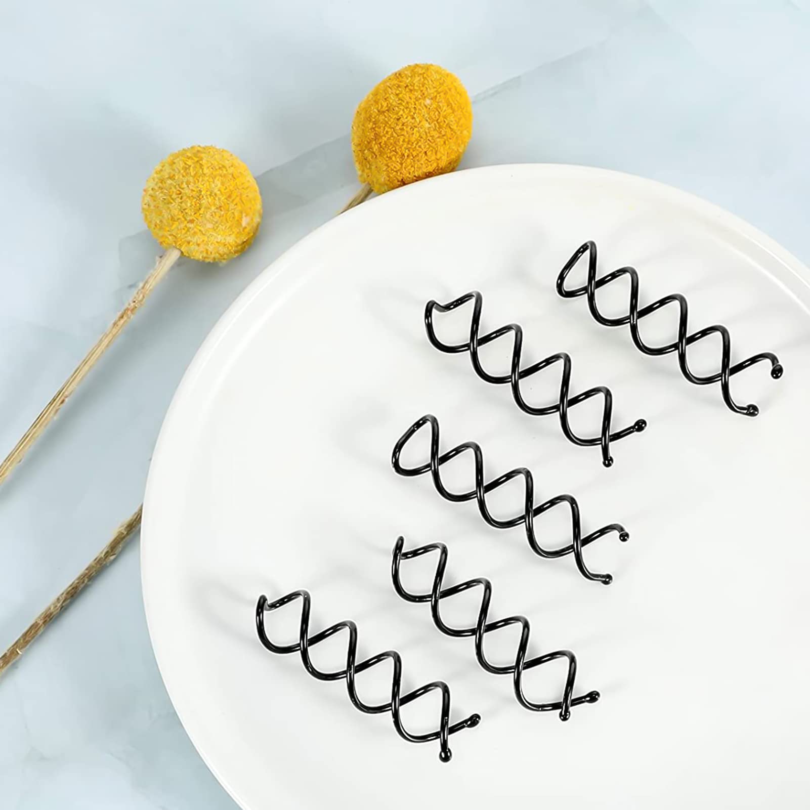 Salon quality bun screw hair pins arranged in a ten piece set layout
