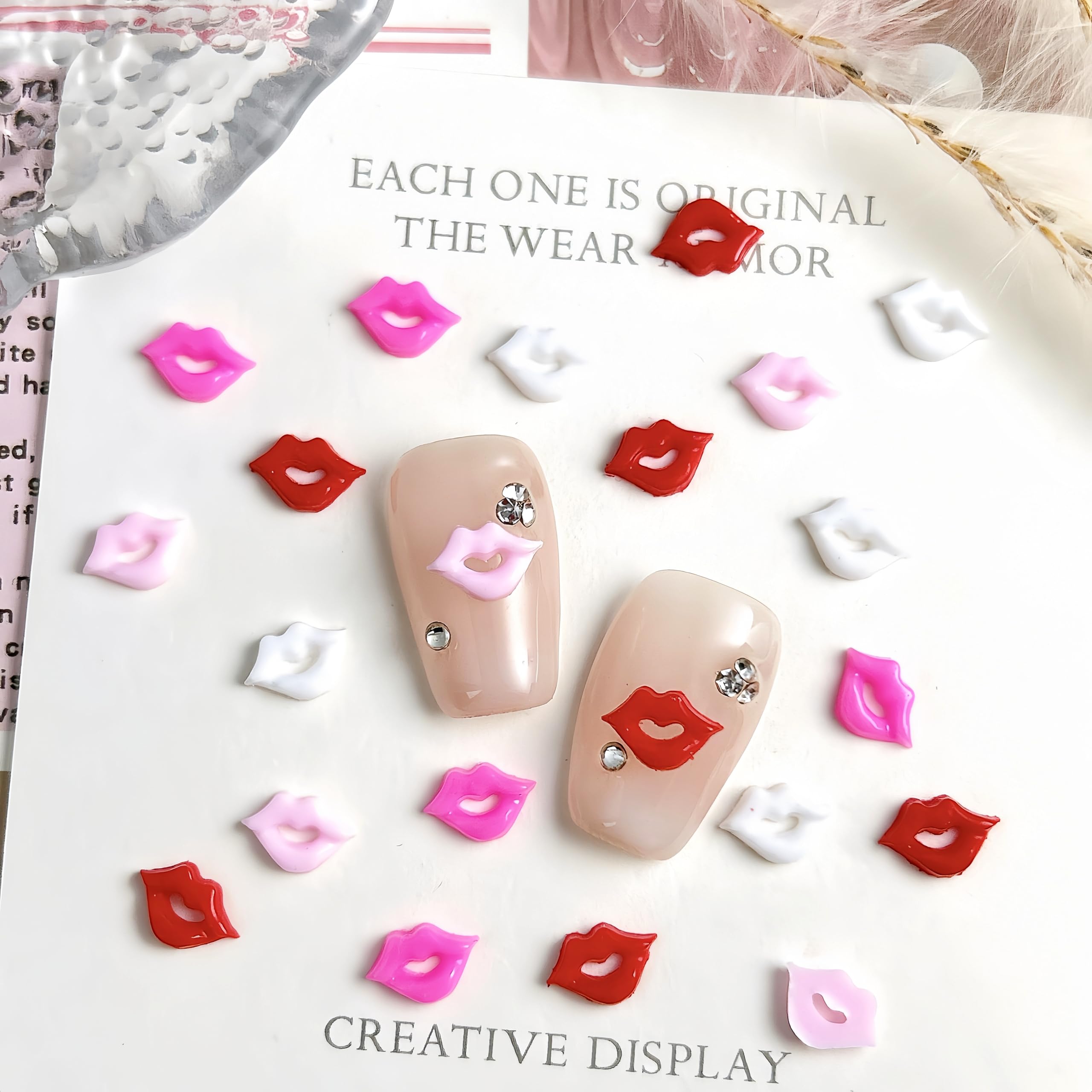 Close up view of 3D red and pink lip nail gems