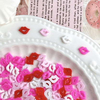 Valentine themed 3D nail art accessories in hand