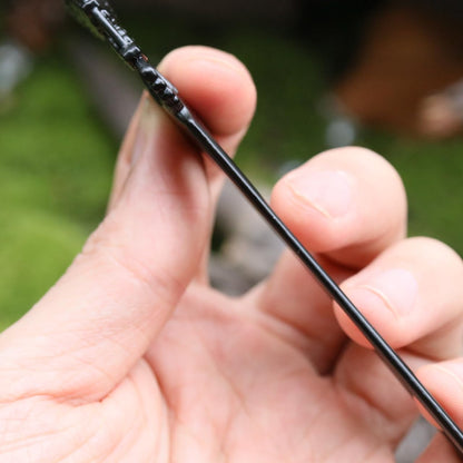 Renaissance festival style metal hair fork securing a messy bun updo