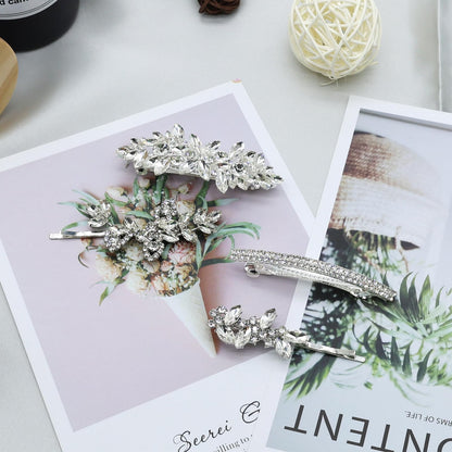 All four pieces of the Mulzile silver leaf rhinestone bridal hair accessories laid out together.