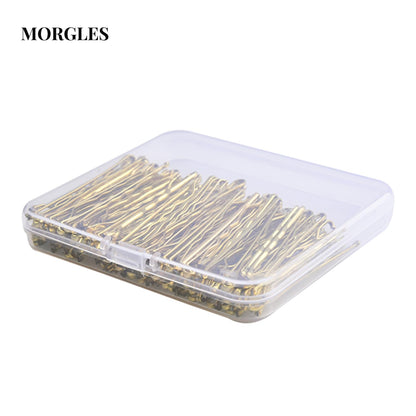 Close up view of MORGLES gold bobby pins highlighting the wavy design and protective rubber tips