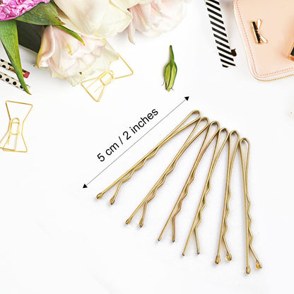 MORGLES premium metallic golden hair pins arranged neatly outside their clear plastic travel case