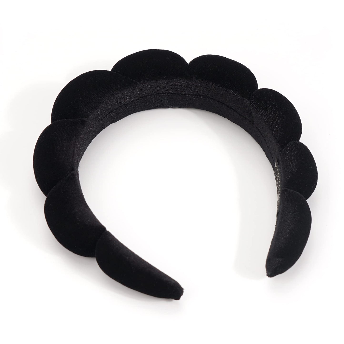 Woman using Ayesha black sponge headband during beauty routine