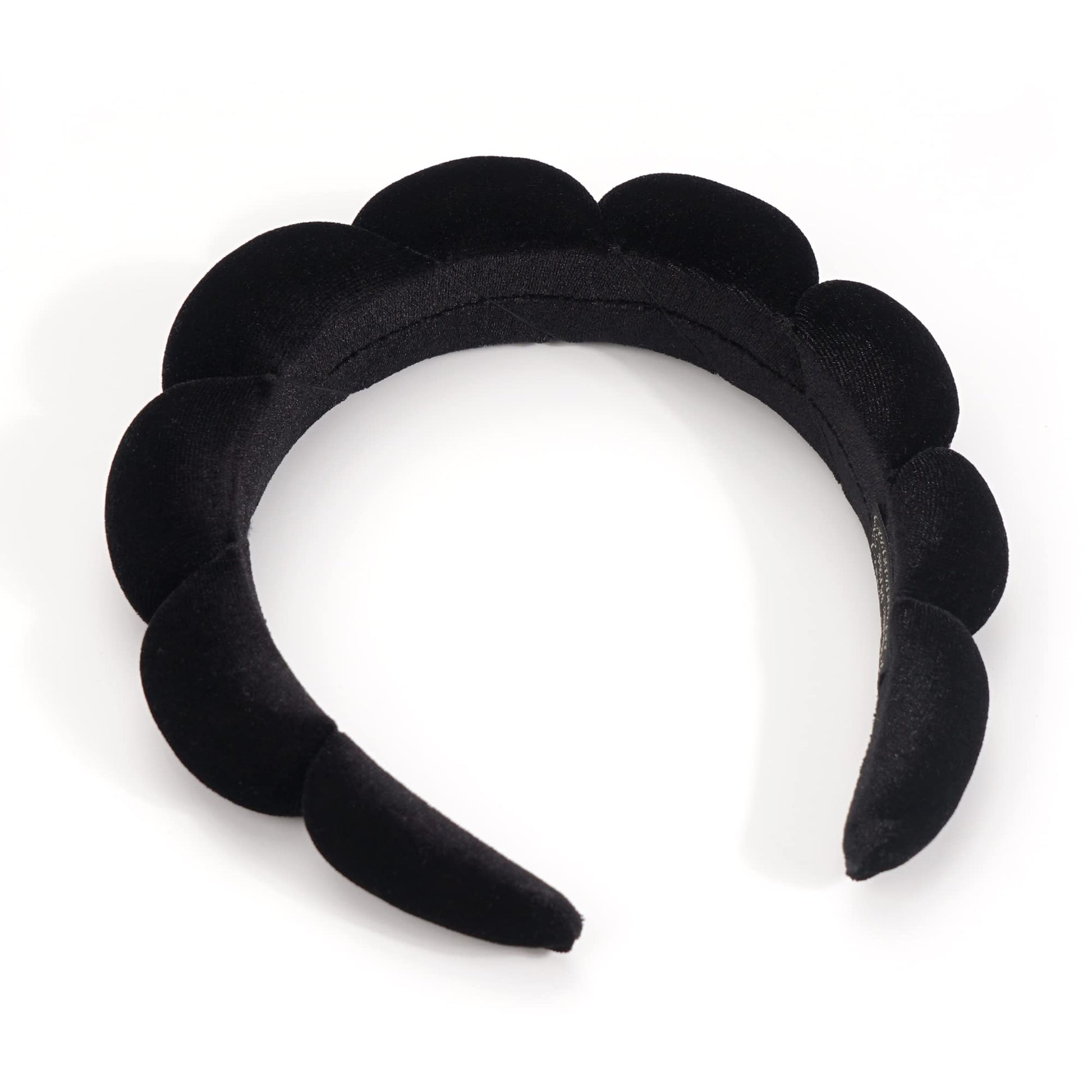 Woman using Ayesha black sponge headband during beauty routine