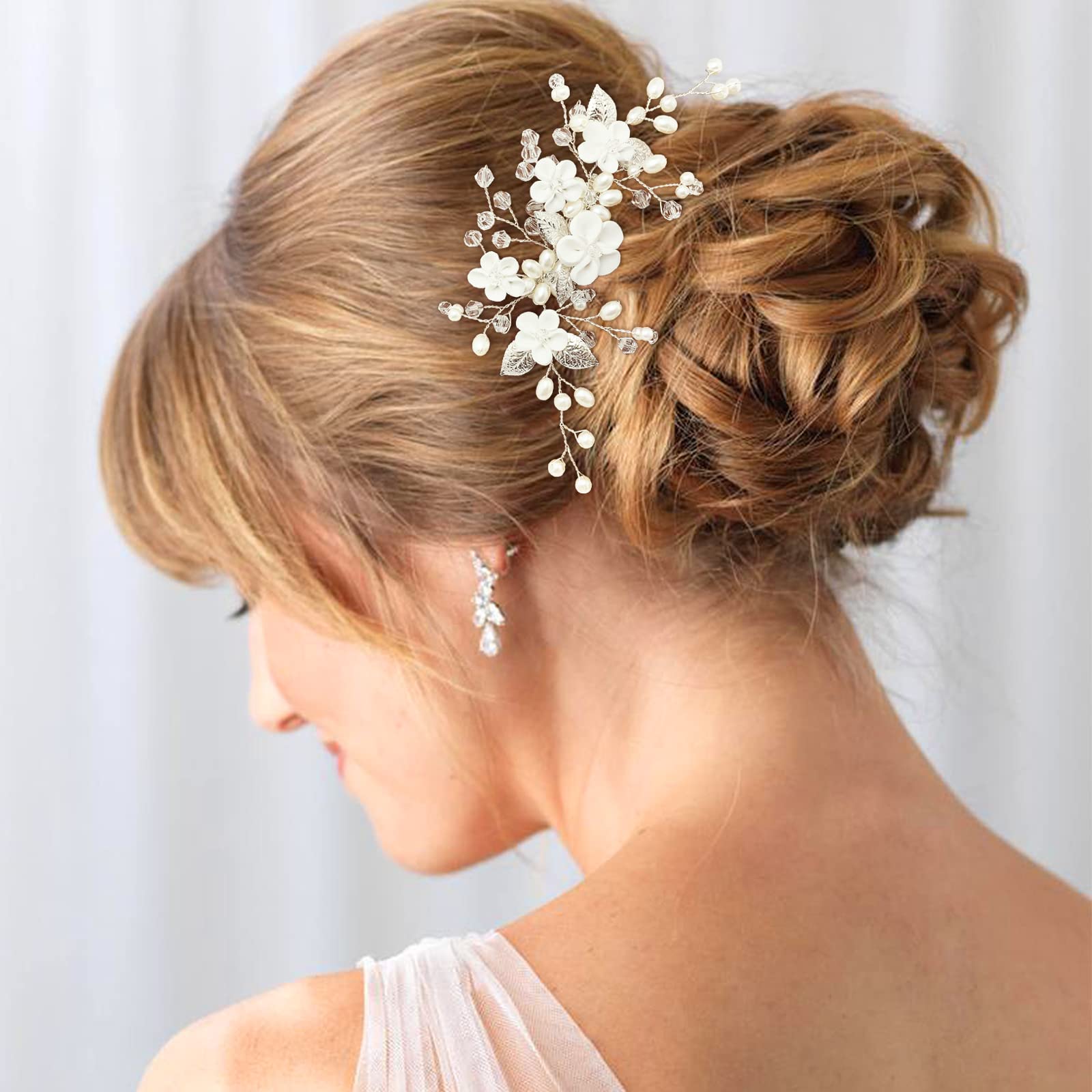 PrettyLife silver leaf wedding hair comb close up on rhinestone details.