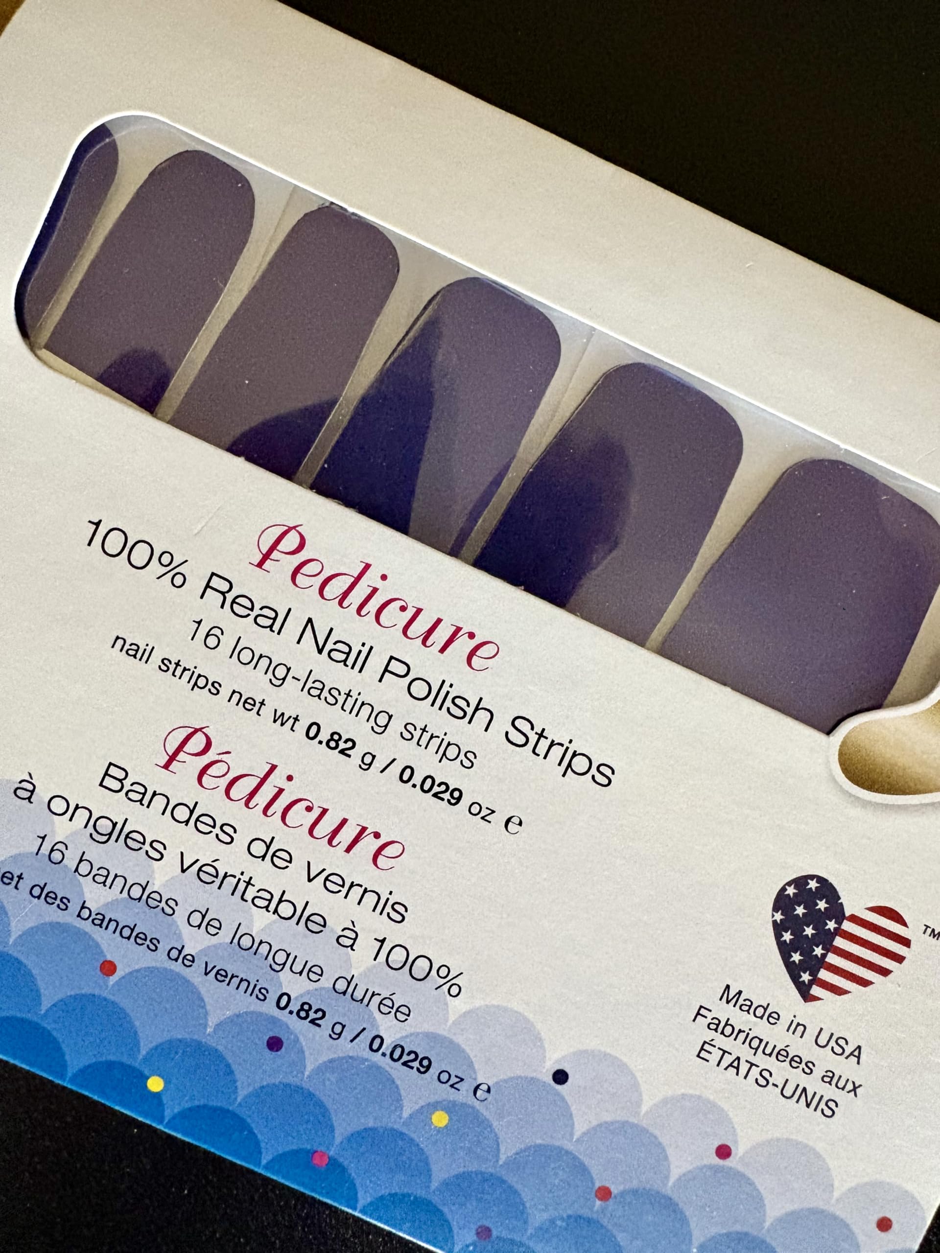 Sixteen double ended Color Street real nail polish pedicure strips in pearlescent deep purple shimmer