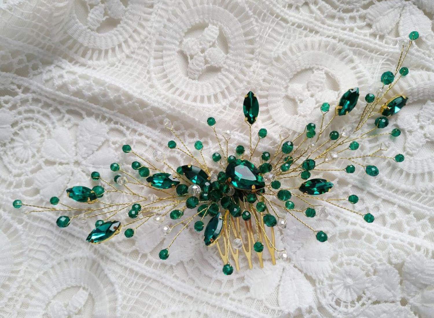 Close up of emerald green crystals and gold vine detail on hair comb