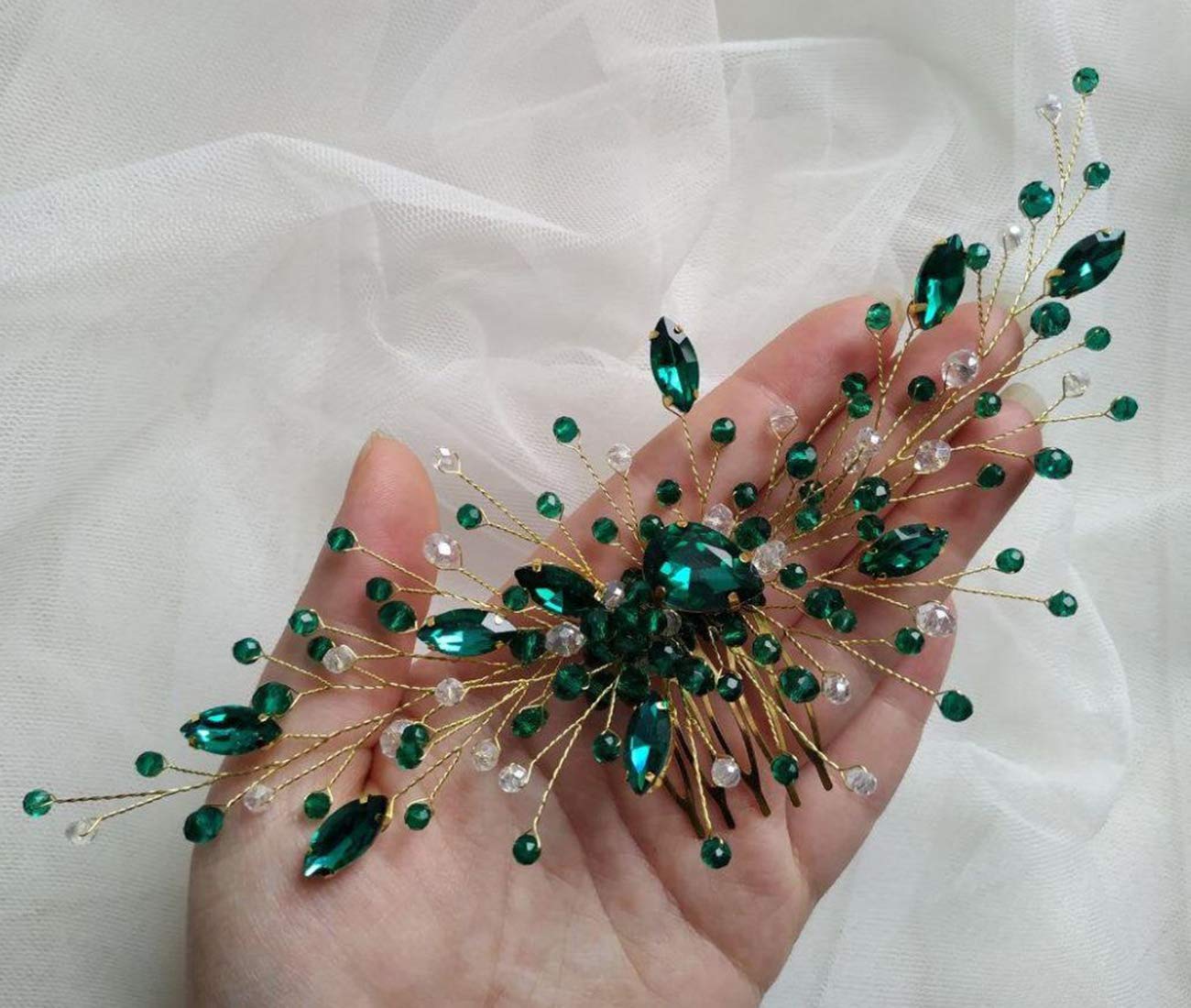 Side profile view of gold vine bridal hair comb with green crystals