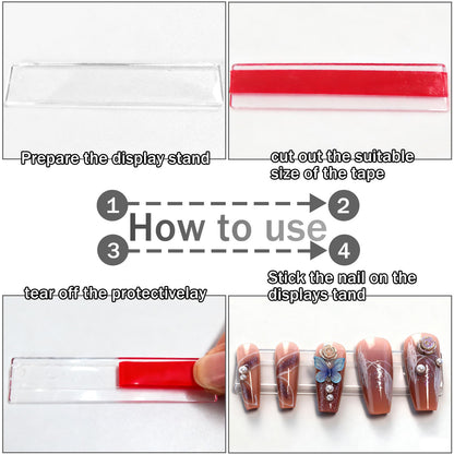 Compact clear acrylic manicure practice strips holding false nails during detailing work close up