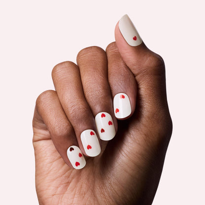 Close-up view of the thirty-two semi-cured gel nail stickers included in the Dashing Diva Valentine manicure kit.
