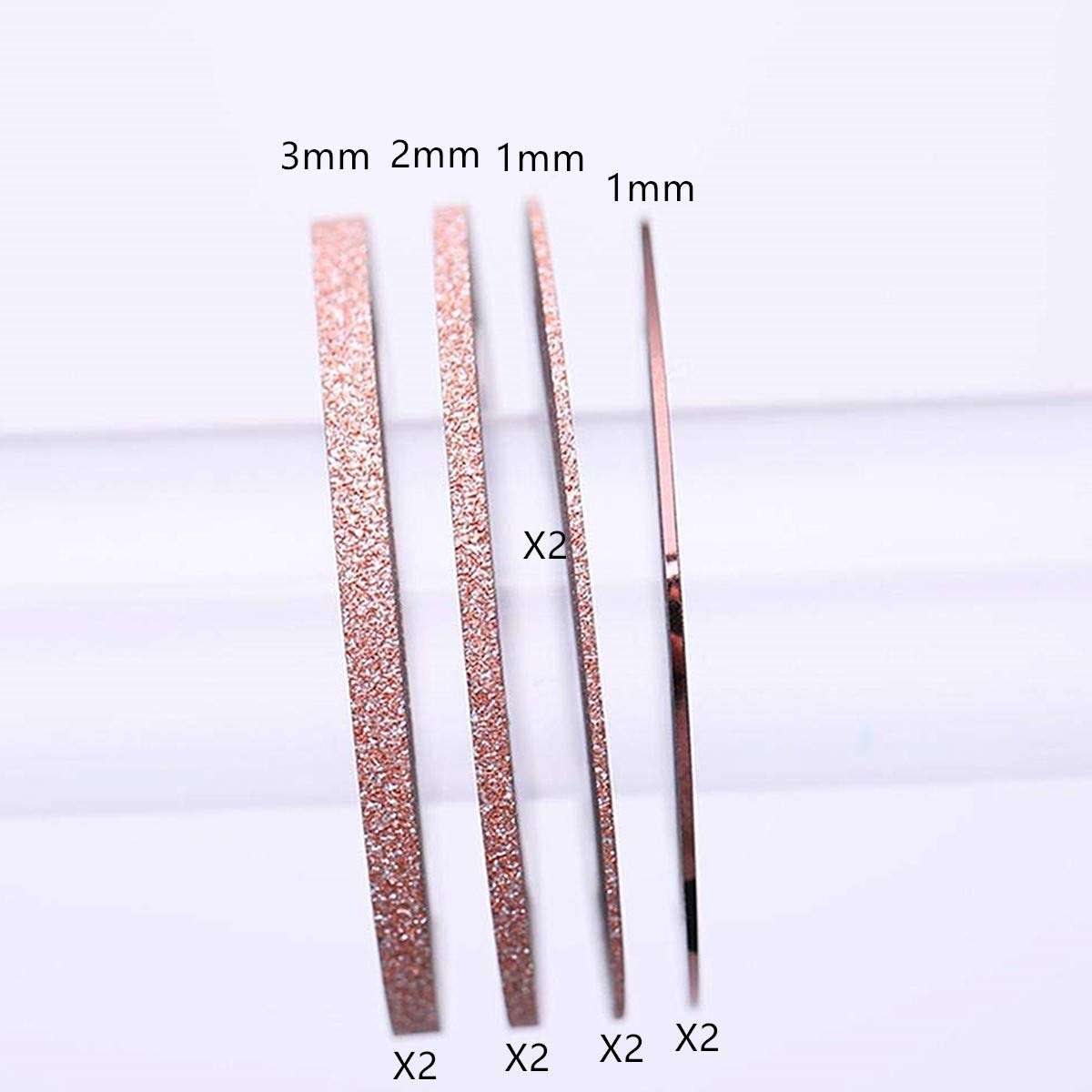 Close up of rose gold matte glitter nail tape rolls