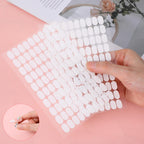 Nail technician workspace setup with clear adhesive strips and display stands