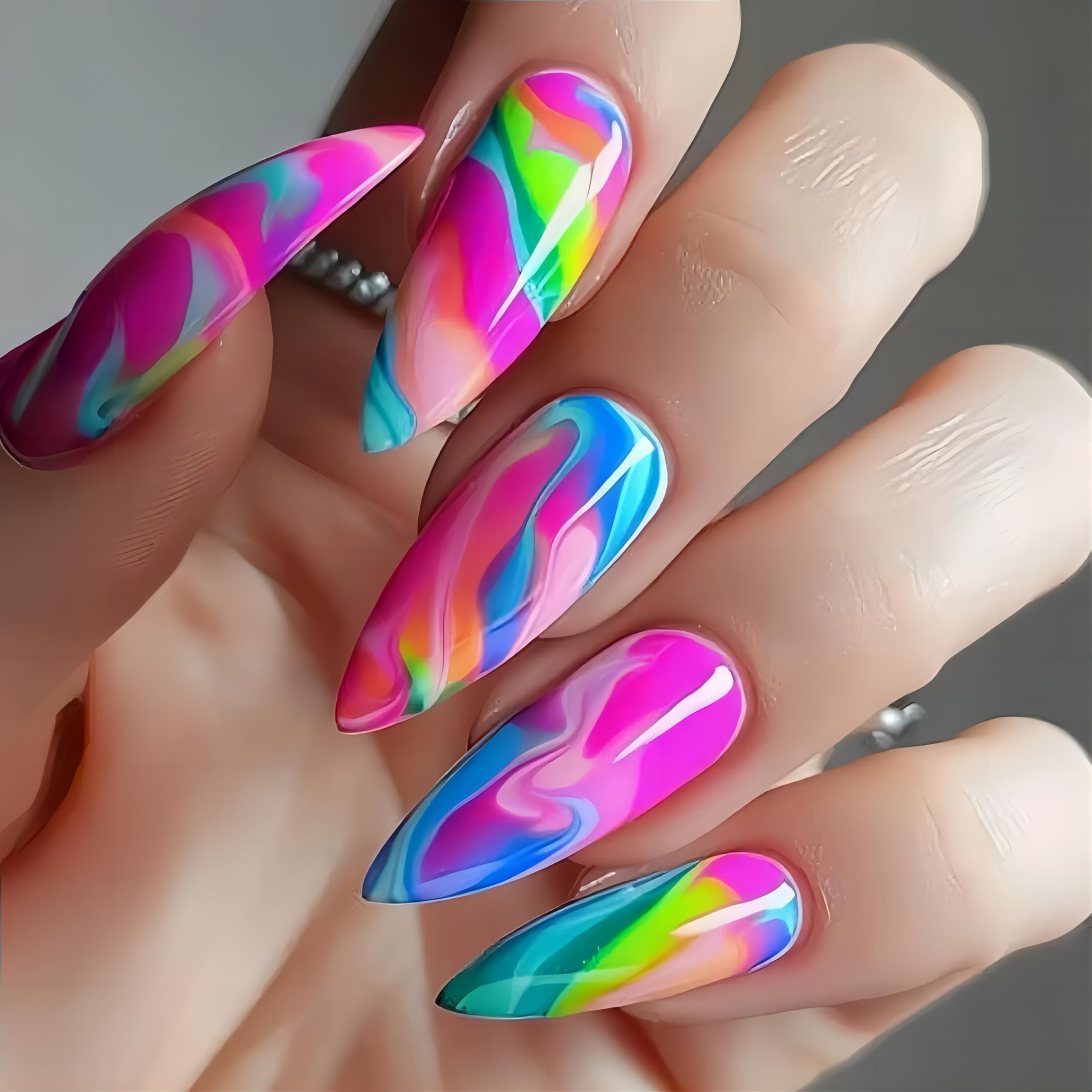 Close up of colorful gradient gel nail sticker wraps applied on manicured hands.