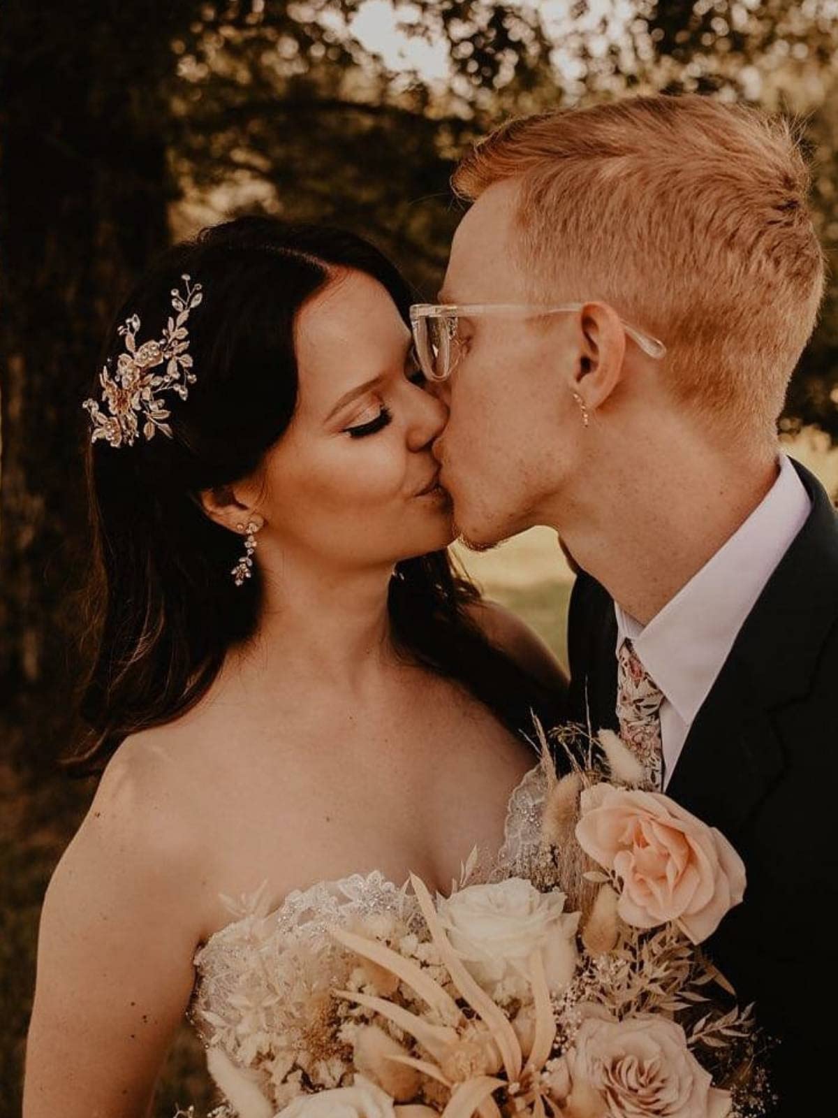 Side profile of rose gold bridal hair accessory in wedding hairstyle