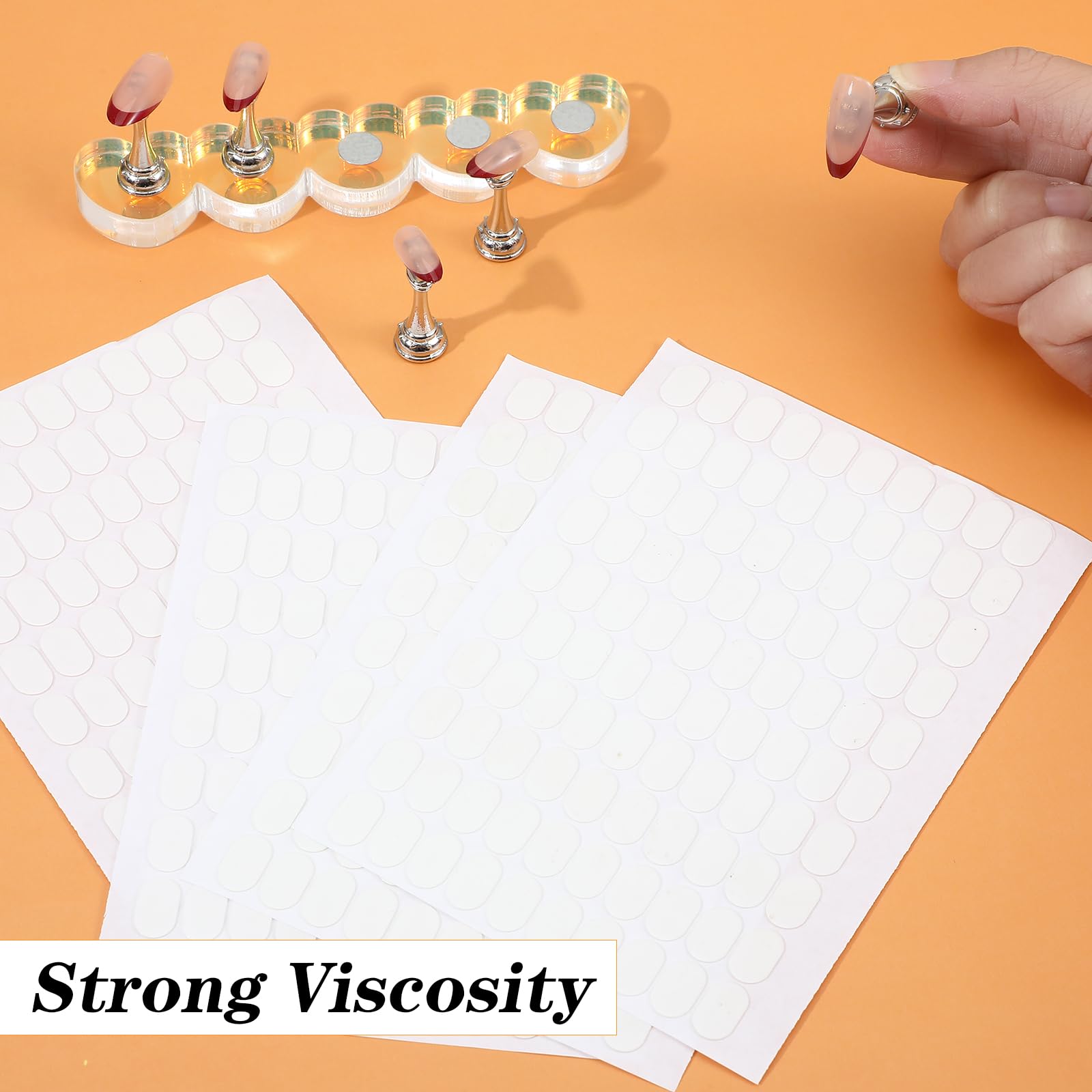 Waterproof testing of the LXUEJIE clear nail adhesive tabs under running water.