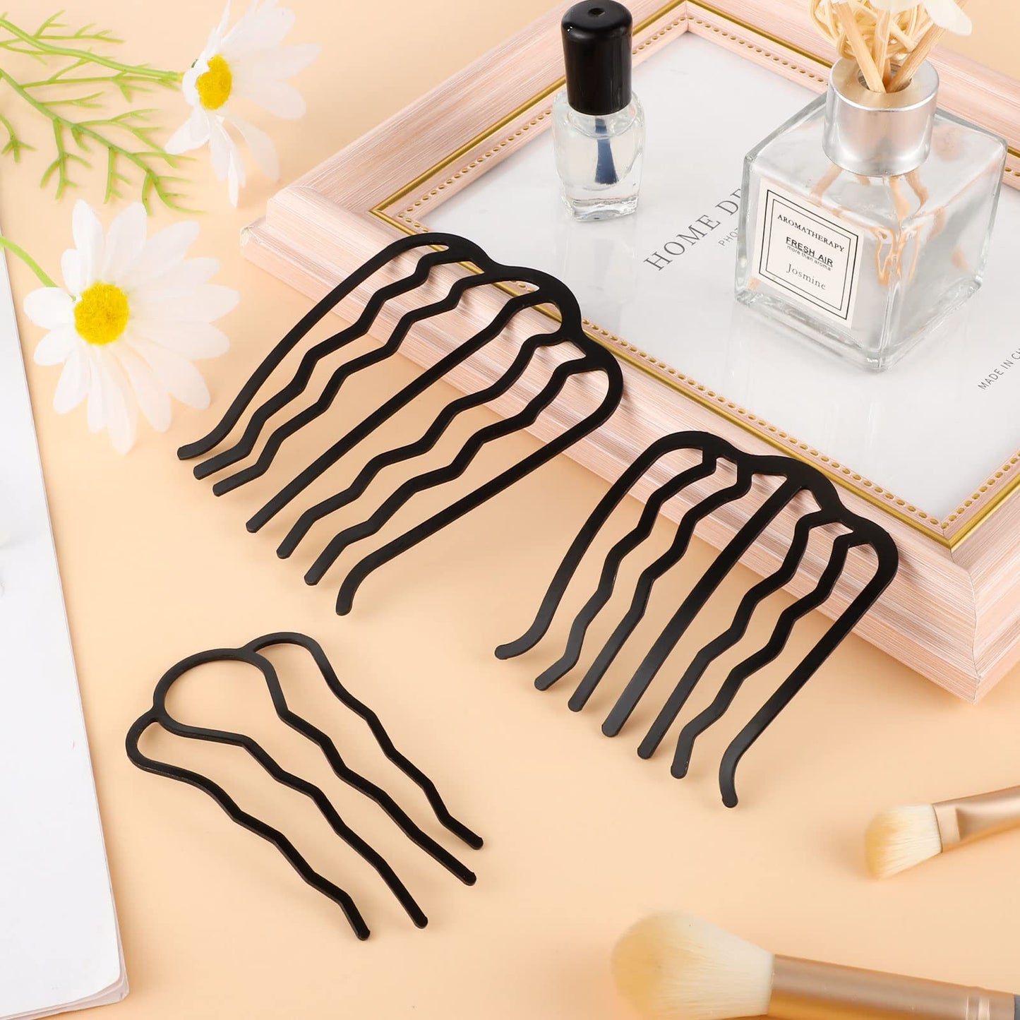 Besarme black metal side combs demonstrating the 4-prong hair tool for securing buns.