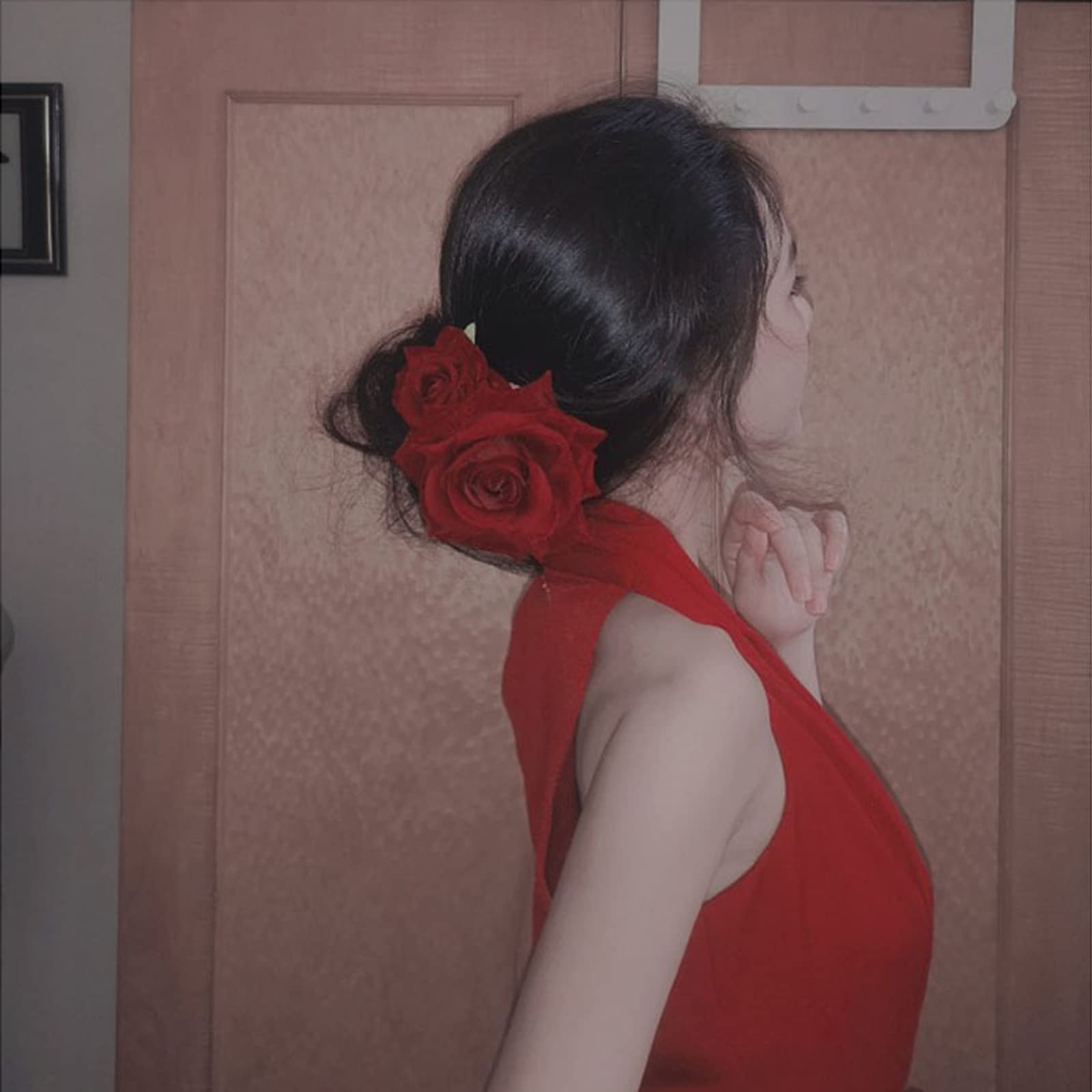 Premium velvet red rose brooch pinned onto an elegant dress fabric